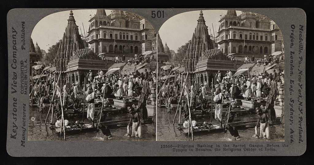 Pilgrims bathing in the sacred Ganges before the temple in Benares, the religious center in India