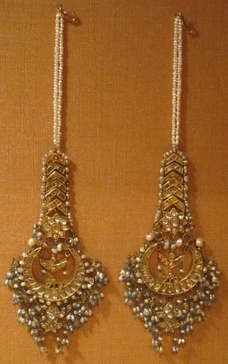Mughal gold earrings strewn with gemstones,
