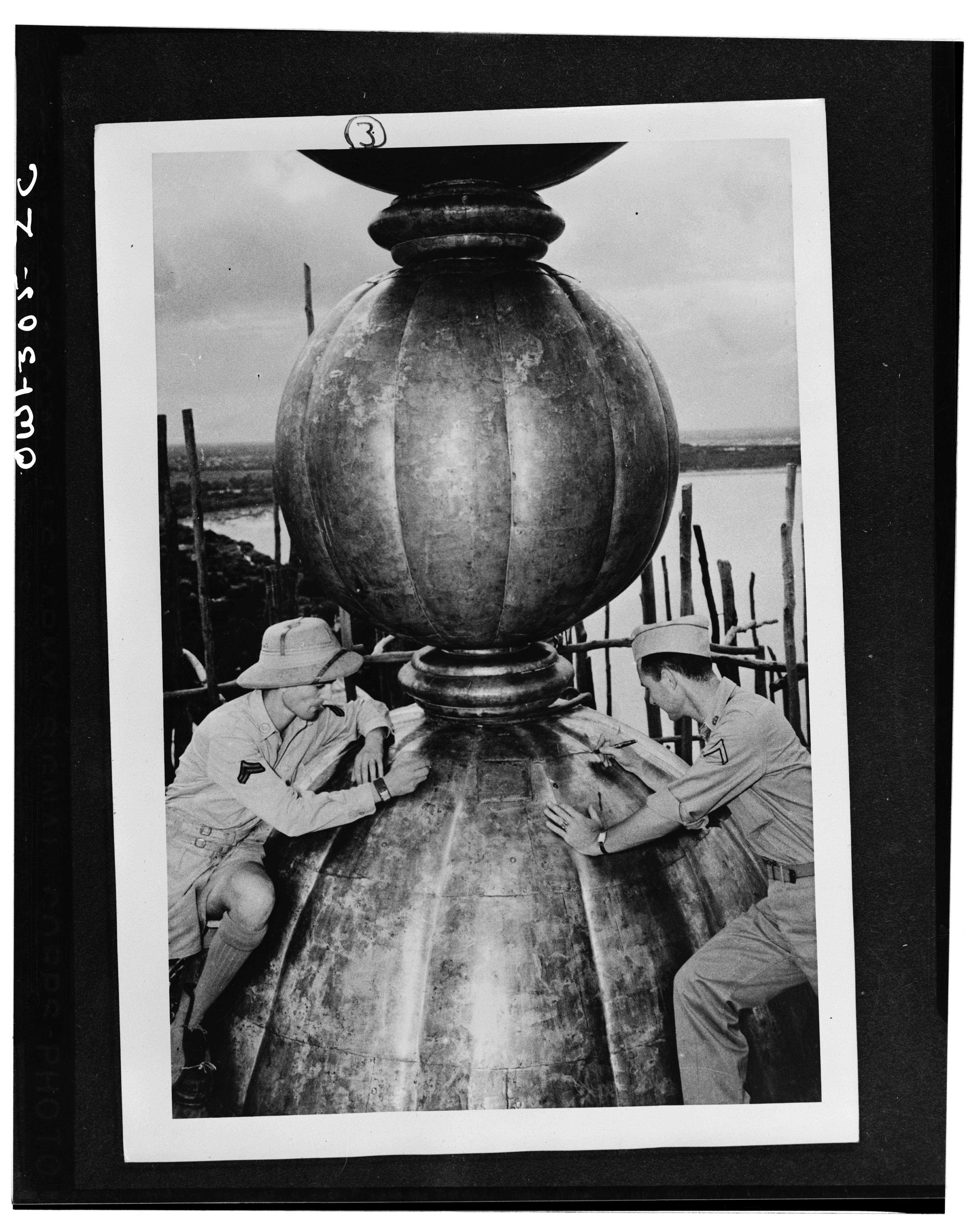 Agra (vicinity), India. Adventurous soldiers climb 250 feet up the repair scaffold to the top of the Taj Mahal dome, where they place their initials. Left: Corporal Anthony J. Scopelliti, and Private First Class John C. Byron, Jr.